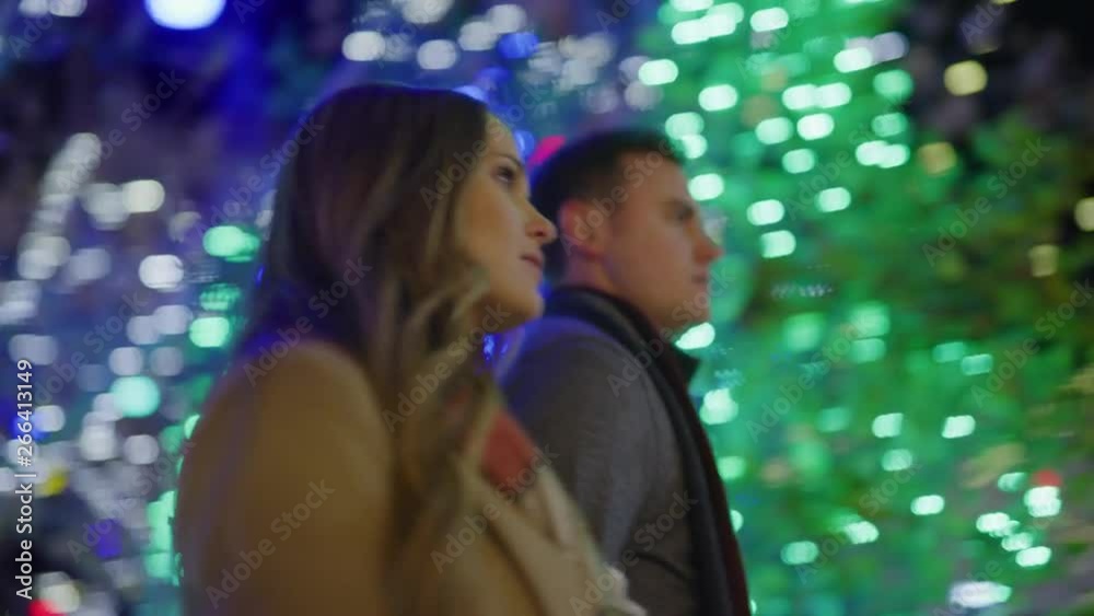 Slow motion low angle view of couple walking outdoors during Christmas / Provo, Utah, United States Slow motion low angle view of couple walking outdoors during Christmas / Provo, Utah, United States