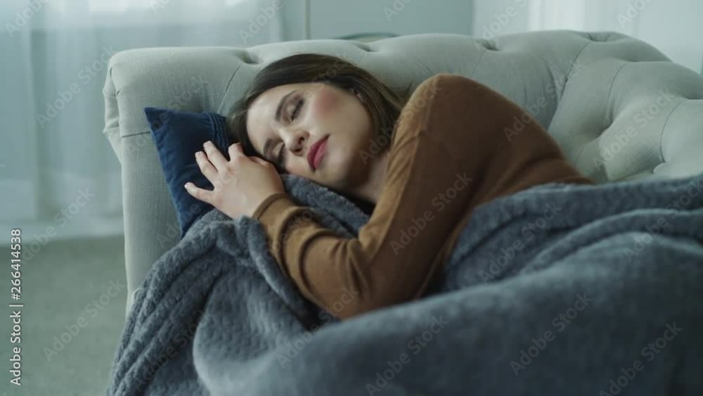 Panning shot of woman laying on sofa napping / Cedar Hills, Utah, United States Panning shot of woman laying on sofa napping / Cedar Hills, Utah, United States