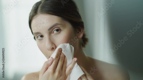 Close up of woman washing face with washcloth in mirror / Cedar Hills, Utah, United States photo