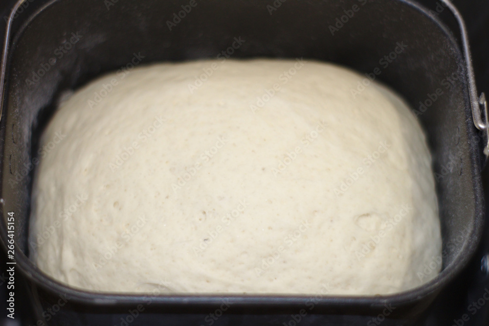 The process of making bread at home. Dough in bread maker The process of making bread at home. Dough in bread maker