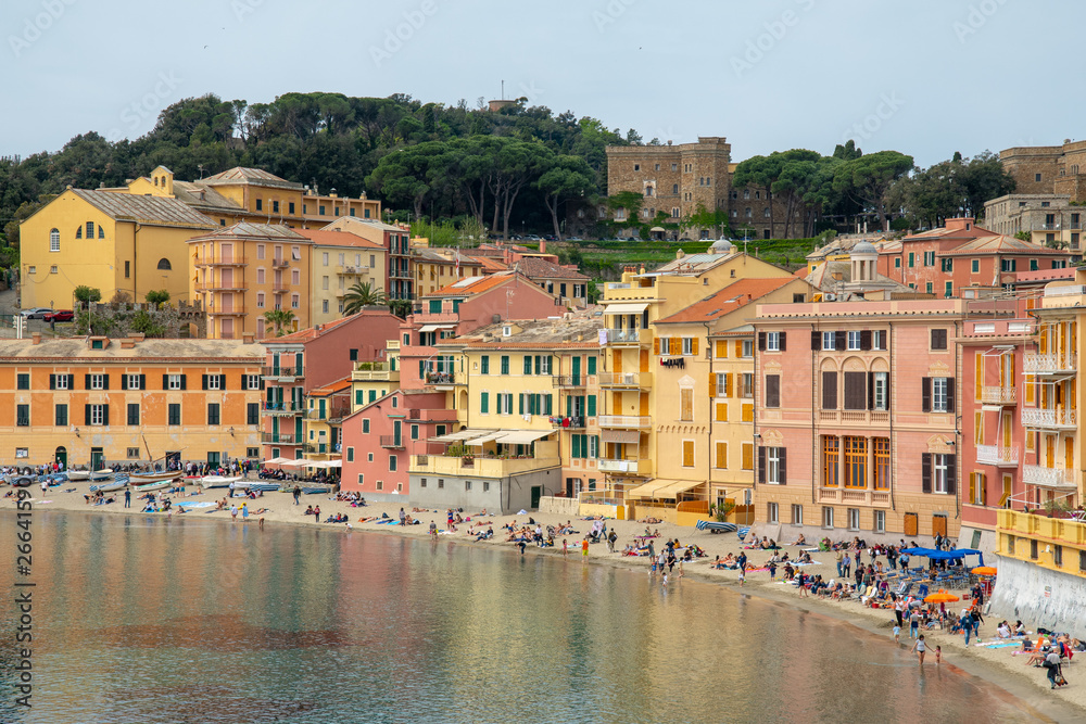 High angle view of the Bay of Silence in the ancient fishing village of Sestri Levante with the typical colored houses and people on the beach in a sunny day, Liguria, Italy