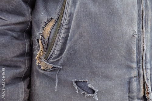 Torn outerwear. Ragged blue clothes. photo