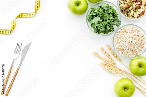 Weight loss concept with green organic food on white background top view space for text photo