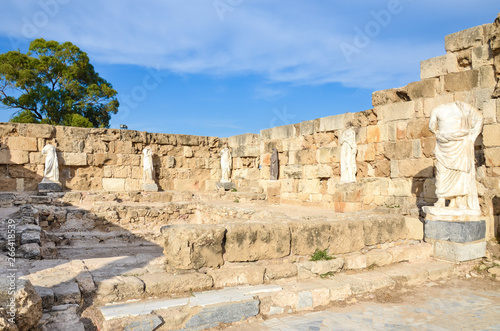 Well preserved ruins of ancient Salamis in Turkish Northern Cyprus with antique statues. Taken on a sunny day with blue sky above. The landmark is a popular tourist attraction.