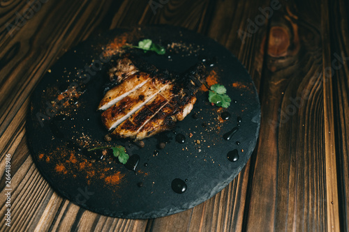 Pork bone steak on a wooden background with honey. Board slate. kenza, pepper photo