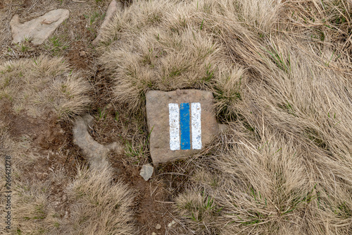 Markings of trails in the mountains. A colorful sign on a mountain stone. photo