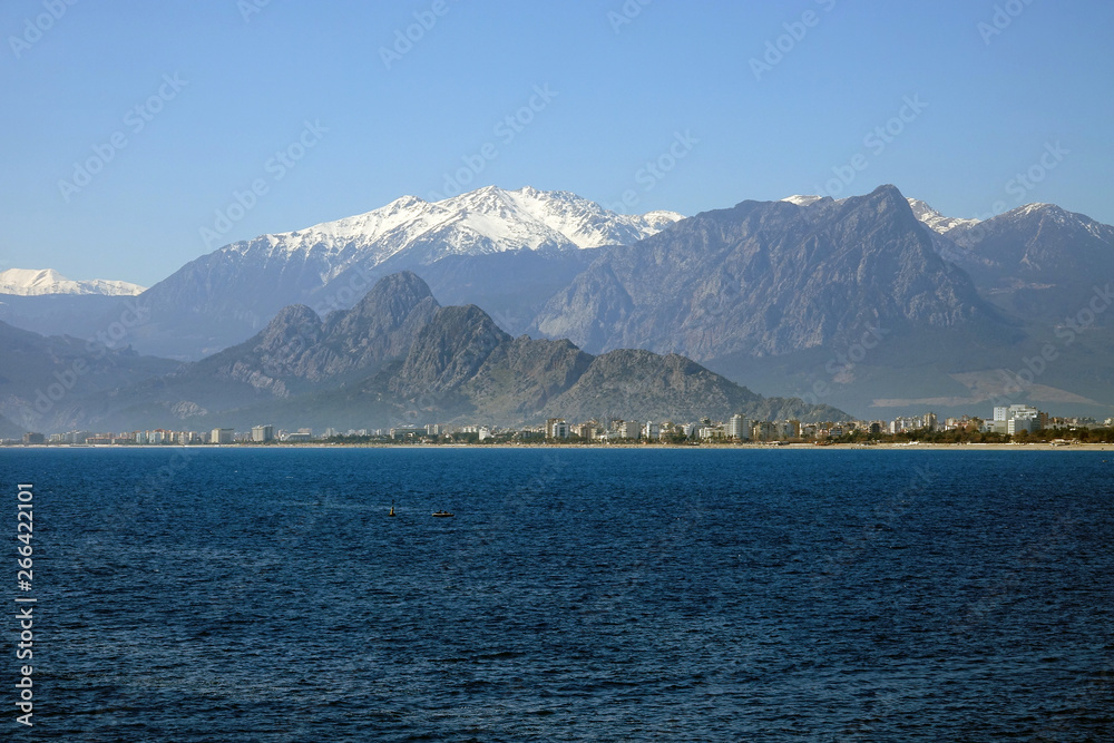 Mediterranean sea  and high mountains with snowy summit over clear blue sky in Antalya, Turkey