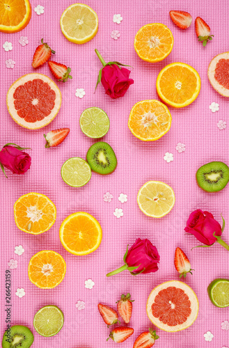 Fototapeta Naklejka Na Ścianę i Meble -  Summertime theme background with fruit, citrus and flowers on pink backdrop.