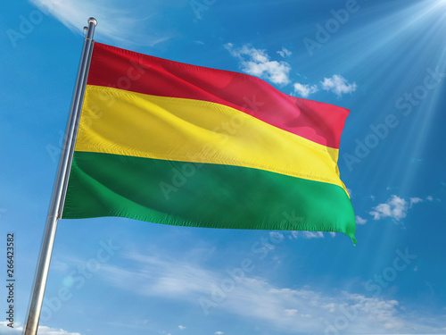 Bolivia National Flag Waving on pole against sunny blue sky background. High Definition