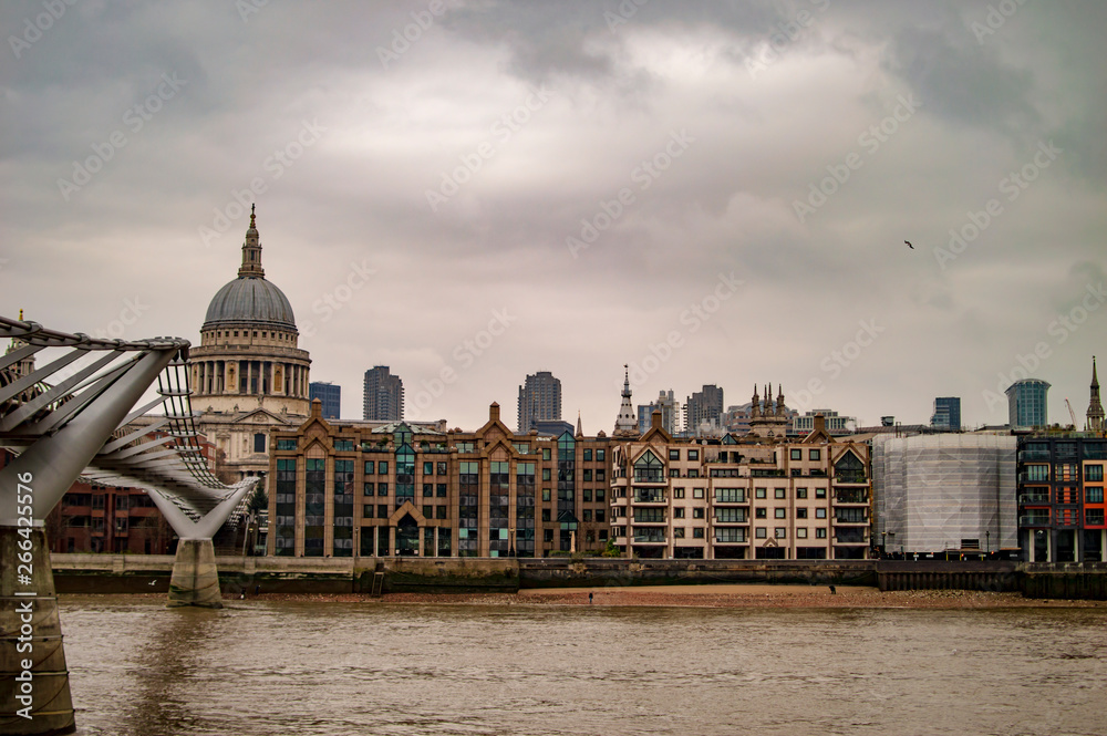 London river thames and the millennium bridge with buildings across