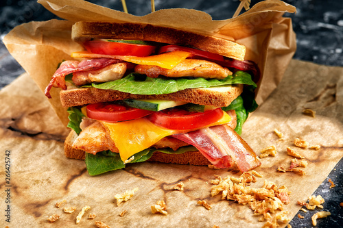 Freshly made clubsandwiches served on a wooden chopping board photo