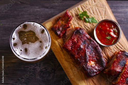 Beer and pork spare ribs. Beer and meat. Glass of ale. View from above, top studio shot