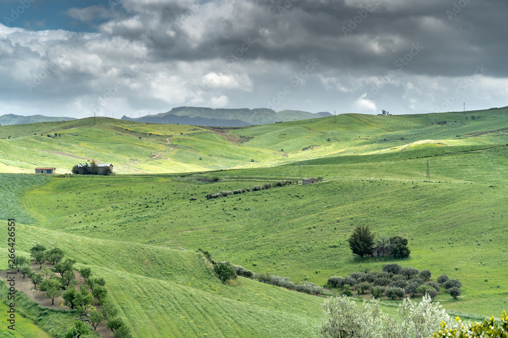 Sicilian landscape with green heels and suggestive clouds Sicilian landscape with green heels and suggestive clouds