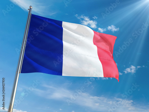 France National Flag Waving on pole against sunny blue sky background. High Definition