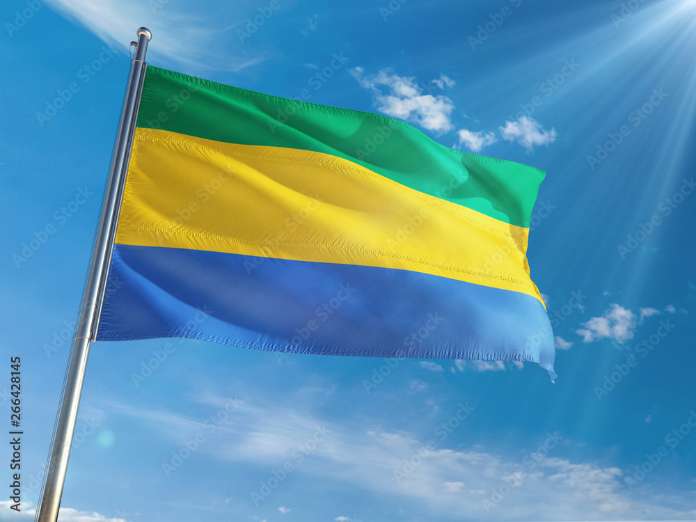 Gabon National Flag Waving on pole against sunny blue sky background. High Definition Gabon National Flag Waving on pole against sunny blue sky background. High Definition