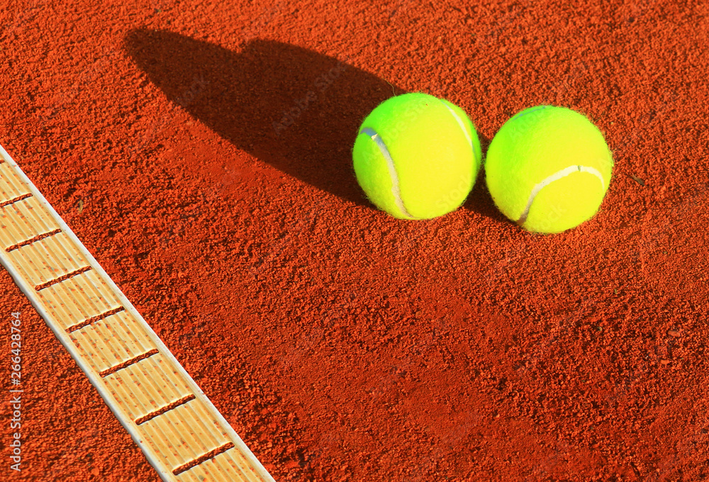 Tennis balls on a tennis clay court