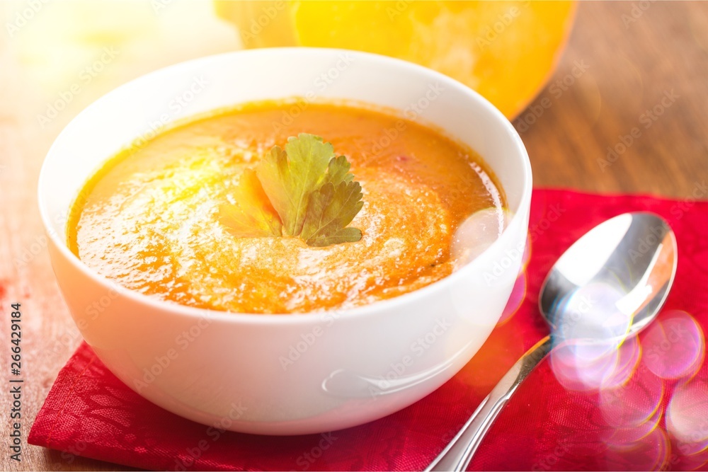 Tasty Pumpkin or carrot soup on background Tasty Pumpkin or carrot soup on background
