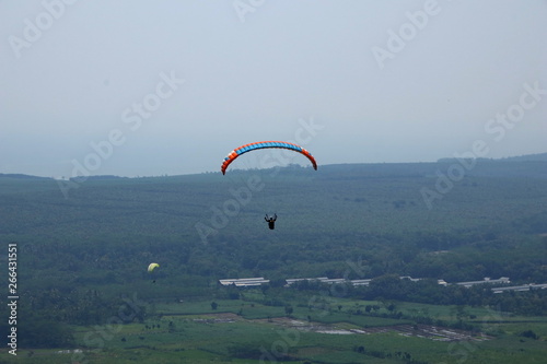 Paragliding athletes while competing in the national championship, flying from a Sikuping hill in Batang Central Java