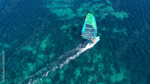 Photography Aerial top view photo of fit man practising wind surfing in exotic open ocean ba