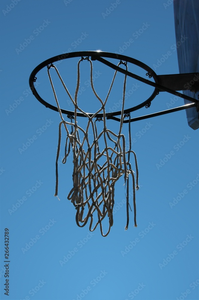 Worn out basketball hoop on a clear summer day Worn out basketball hoop on a clear summer day