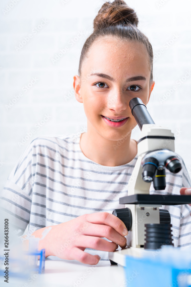 © Alex_Traksel - Teen girl student caring out experiments in chemistry class.high school students with microscopes in laboratory. © Alex_Traksel - Teen girl student caring out experiments in chemistry class.high school students with microscopes in laboratory.