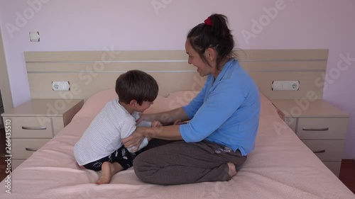 4K Small family wrestling and tickling on bed