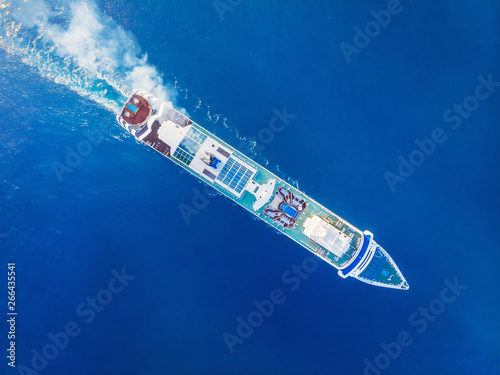 Cruise liner luxury ship in crystal blue Mediterranean sea water. Top aerial view