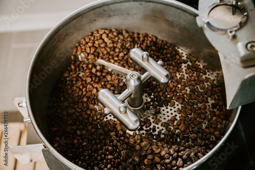 Organic Coffee Beans Roasting in an Industrial Coffee Bean Roaster and Cooling on Mechanical Stirring Pan