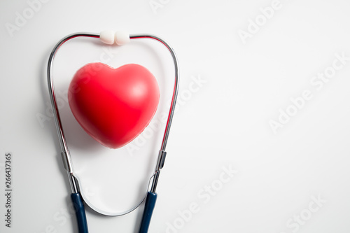 Red heart with stethoscope on white background
