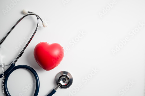 Fototapeta Naklejka Na Ścianę i Meble -  Red heart with stethoscope on white background
