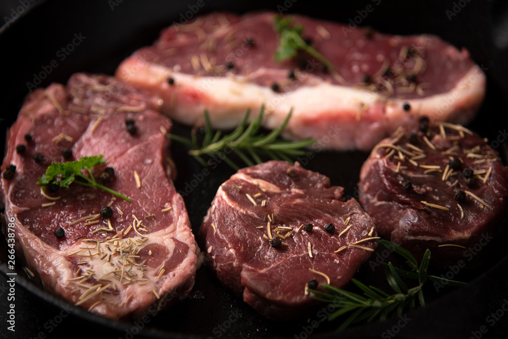 raw beef steak on wooden cutting board