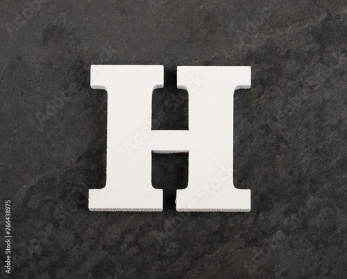 Letter H from blank alphabet on gray background - Top view