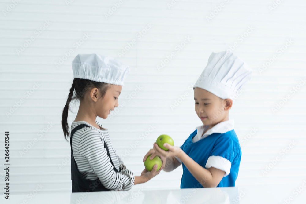 Child chef are happy with apples. Child chef are happy with apples.