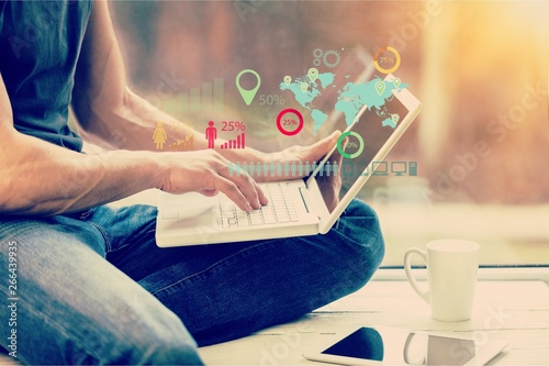 Foto Male hands using laptop on floor at home