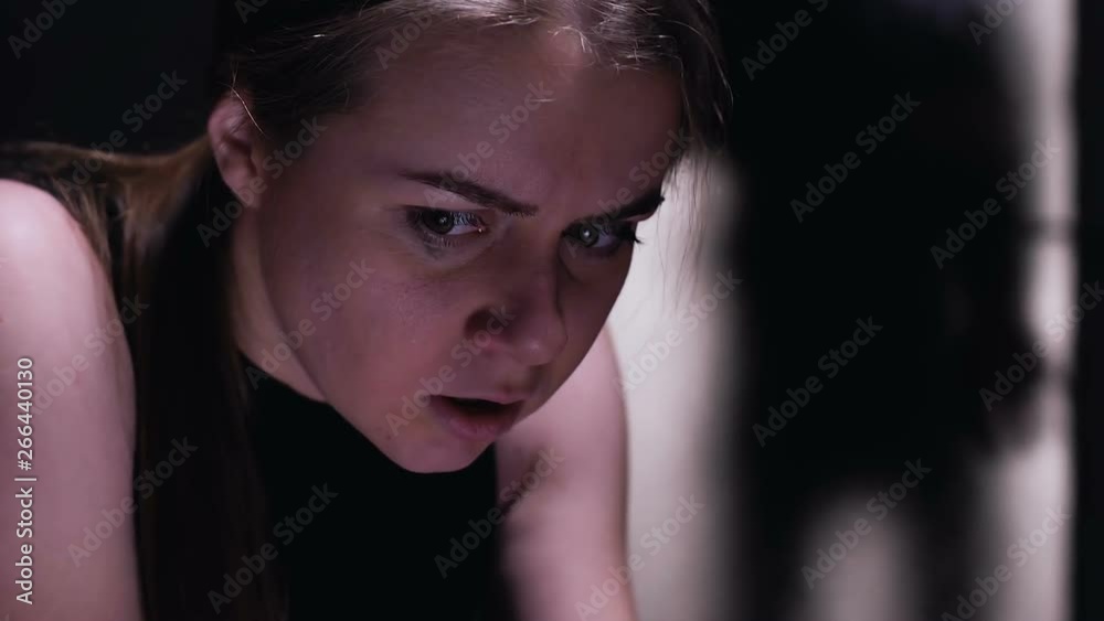 Terrified woman hiding from kidnapper, defenseless victim of sexual assault Terrified woman hiding from kidnapper, defenseless victim of sexual assault
