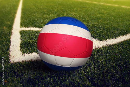 Costa Rica ball on corner kick position  soccer field background. National football theme on green grass.