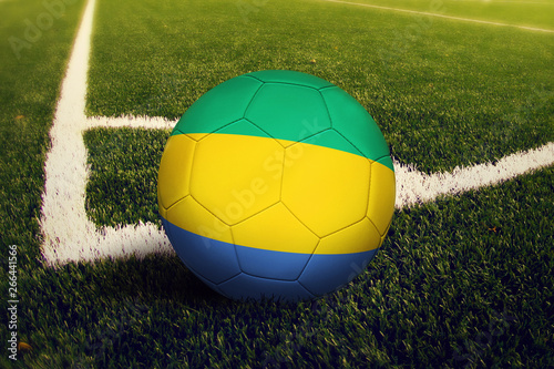 Gabon ball on corner kick position  soccer field background. National football theme on green grass.