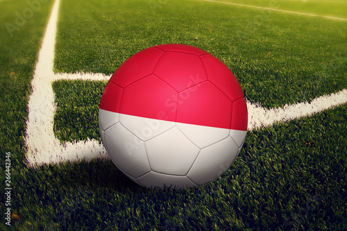 Indonesia ball on corner kick position  soccer field background. National football theme on green grass.