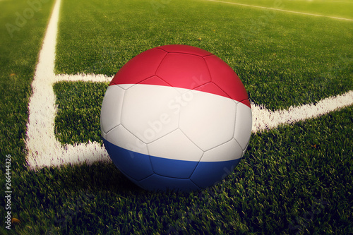 Netherlands ball on corner kick position  soccer field background. National football theme on green grass.