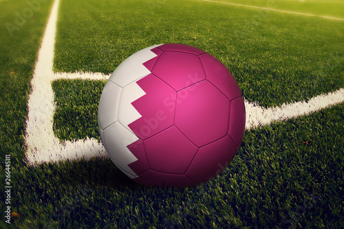 Qatar ball on corner kick position  soccer field background. National football theme on green grass.