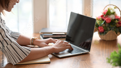 Woman hand on keyboard of laptop while working in home office © bongkarn