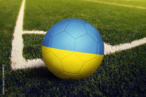 Ukraine ball on corner kick position  soccer field background. National football theme on green grass.