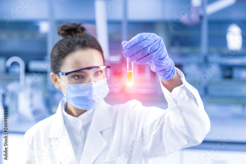 Female scientist looking at the scientific sample in the CDC laboratory 