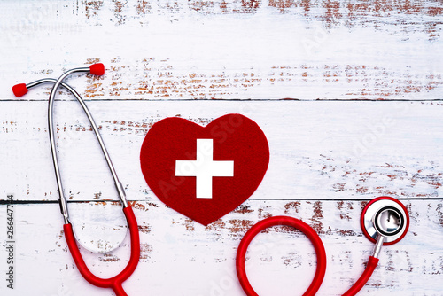 World Red Cross day. Red heart with Stethoscope on wooden table background