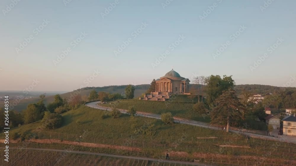 Aerial drone shot of the sepulchral chapel (Grabkapelle) on the Württemberg in Stuttgart, Germany while sunset with beautiful lens flairs