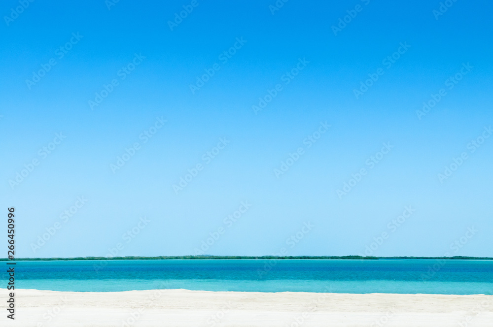 Blue sea white beach under bright sky at Yas Island. Abu Dhabi. UAE