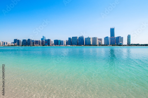 Blue sea at marina island with modern Abu Dhabi skyline cityscape