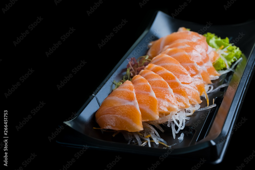 Salmon Sashimi on Black Ceramic Plat,black background. Salmon Sashimi on Black Ceramic Plat,black background.