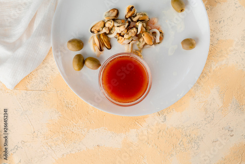 seafood such as shrimps, octopuses and mussels and special sauce in a glass cups