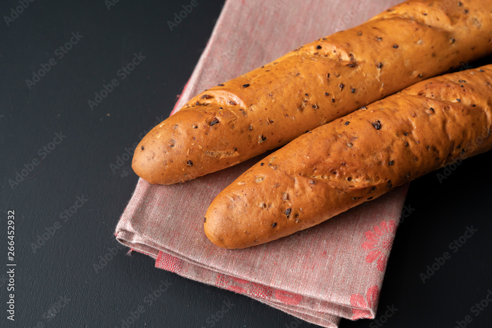 fresh tasty bread or baguette on black surface at the kitchens fresh tasty bread or baguette on black surface at the kitchens